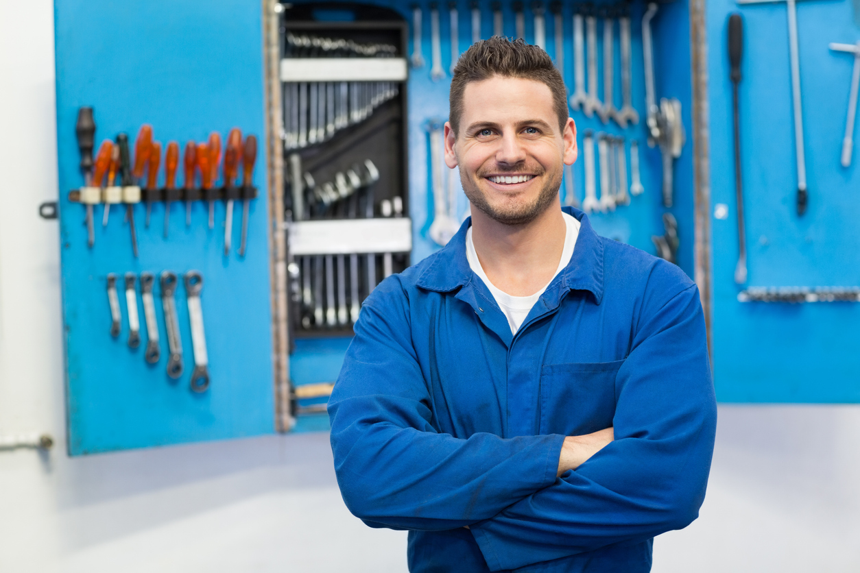 Man infront of a toolbox, smiling